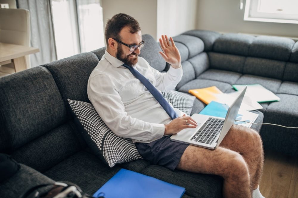 This man with the great legs that is working from home is very accepting of getting the job done remotely and does not welcome any work changes at the present time.