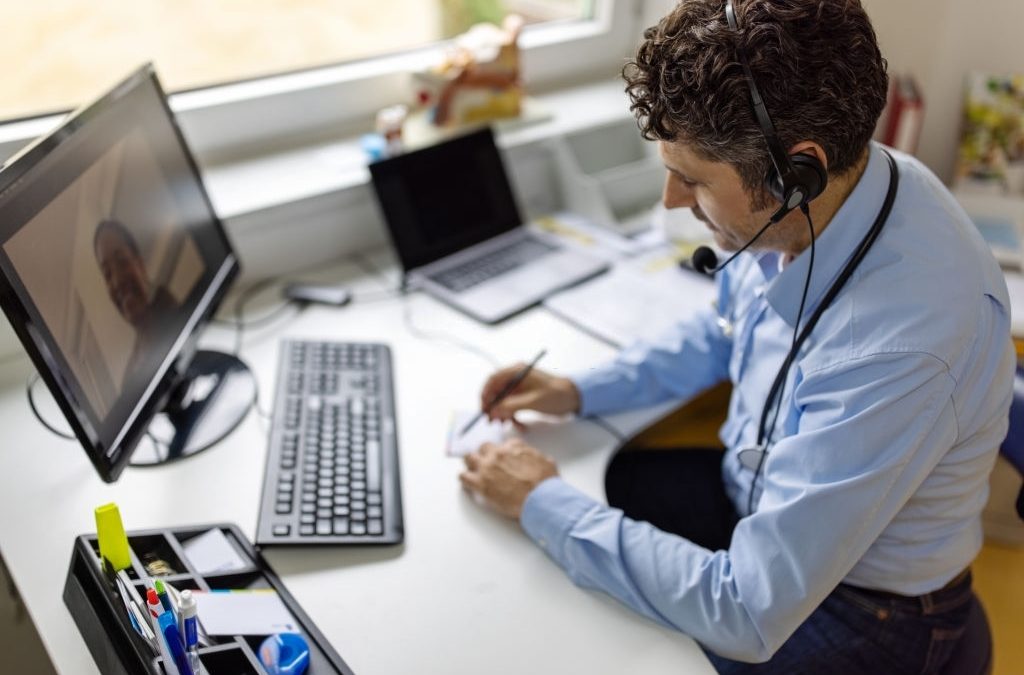 Doctor using VoIP technology to talk to patients.