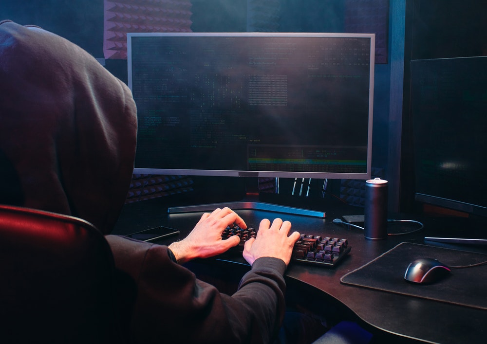 Faceless hacker on a computer