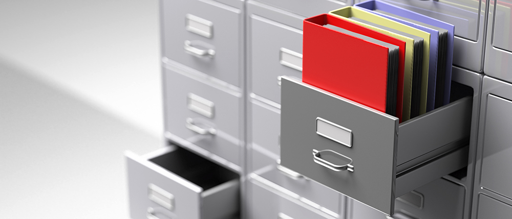 Office file folders in an open cabinet drawer closeup view. 