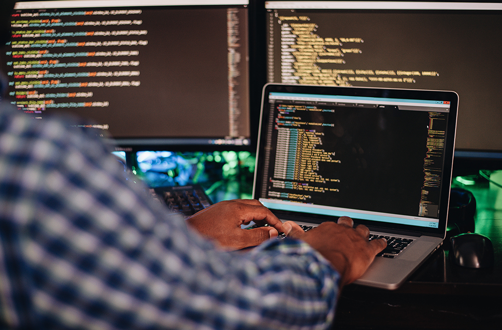 Man coding on a computer