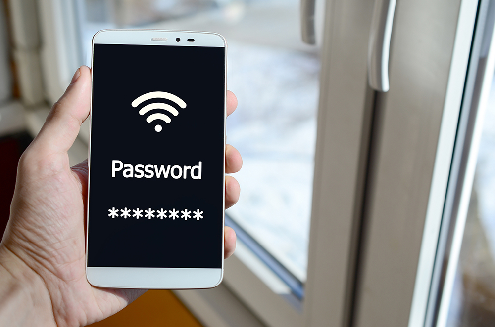 A person sees a white inscription on a black smartphone display that holds in his hand. Password