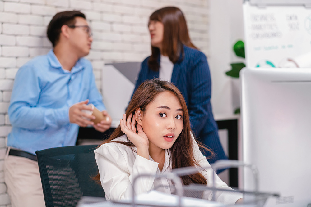 Asian Business woman be curious and listening the couple talking about lovers problem while working hour at modern office, gossip and secret, eavesdrop and whisper, relationship in office concept