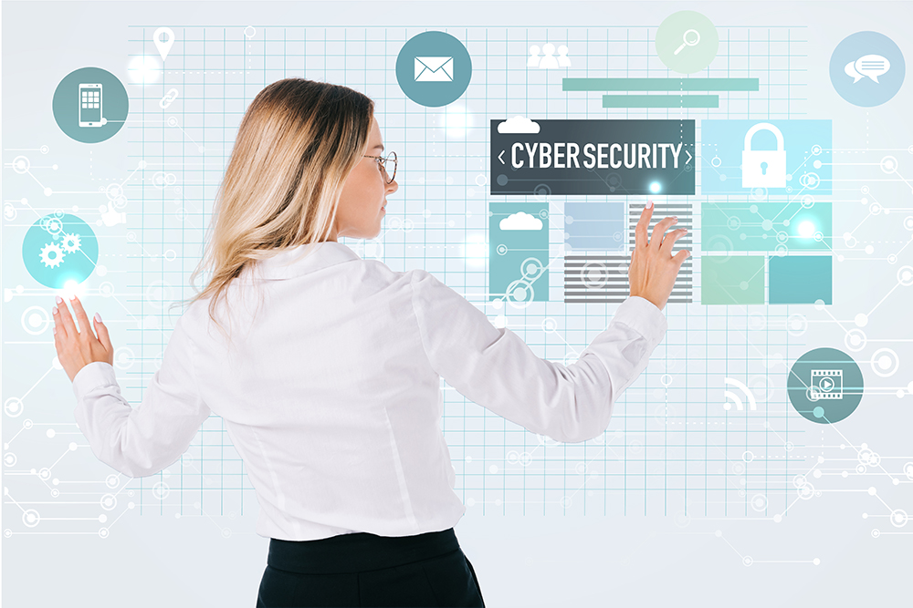 back view of businesswoman in eyeglasses pointing at cyber security signs isolated on white,