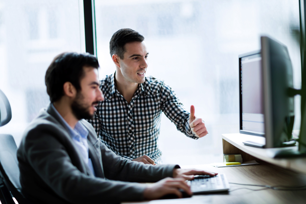 Young businesspeople working on computer in modern office