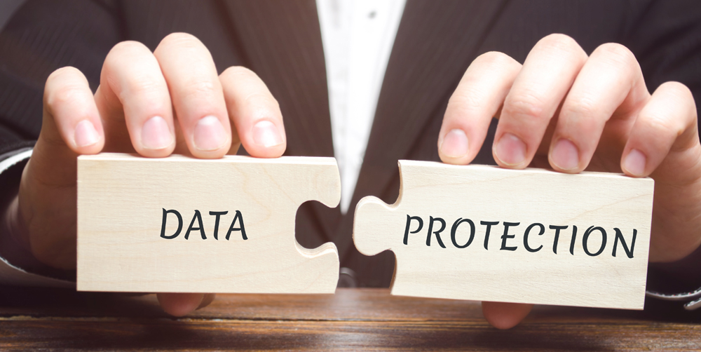 Businessman collects wooden puzzles with the word Data Protection. Denied access to confidential information. Ensuring the confidentiality of personal and business information. GDPR. Cyber Security