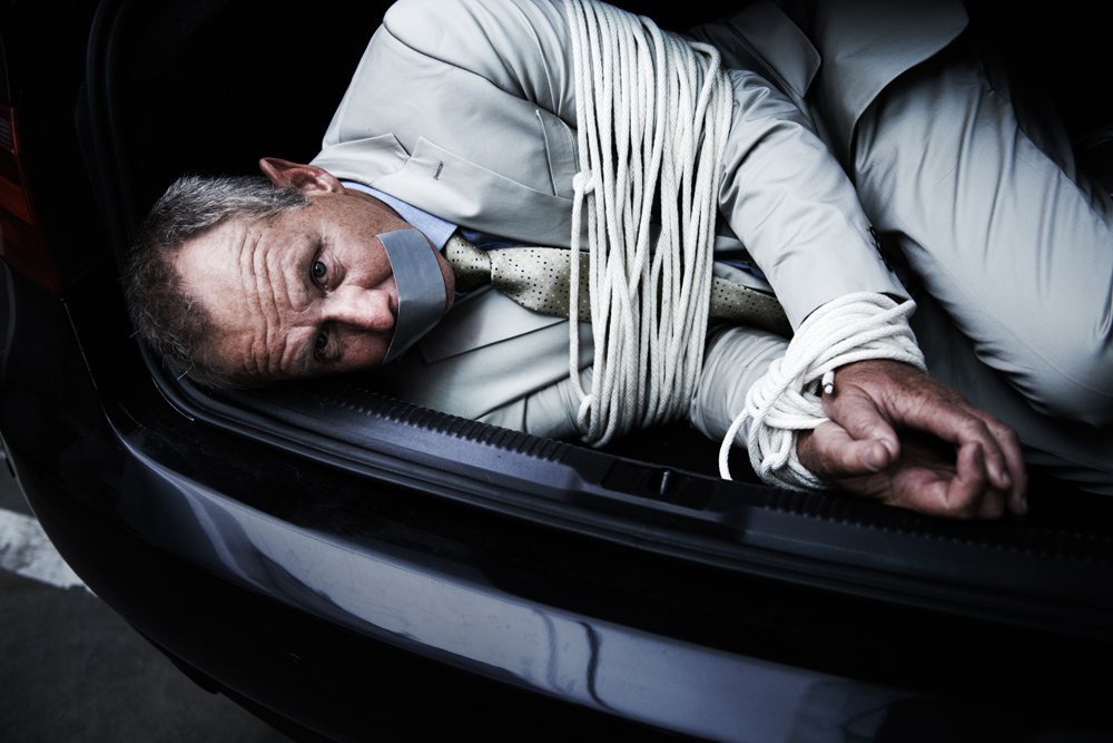 Fearing for his life. A bound and gagged businessman lying in the trunk of a car