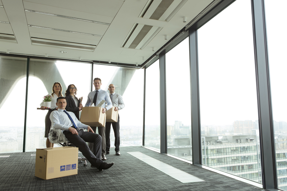 Happy businesspeople that used our IT checklist for office moves have moved into their new office