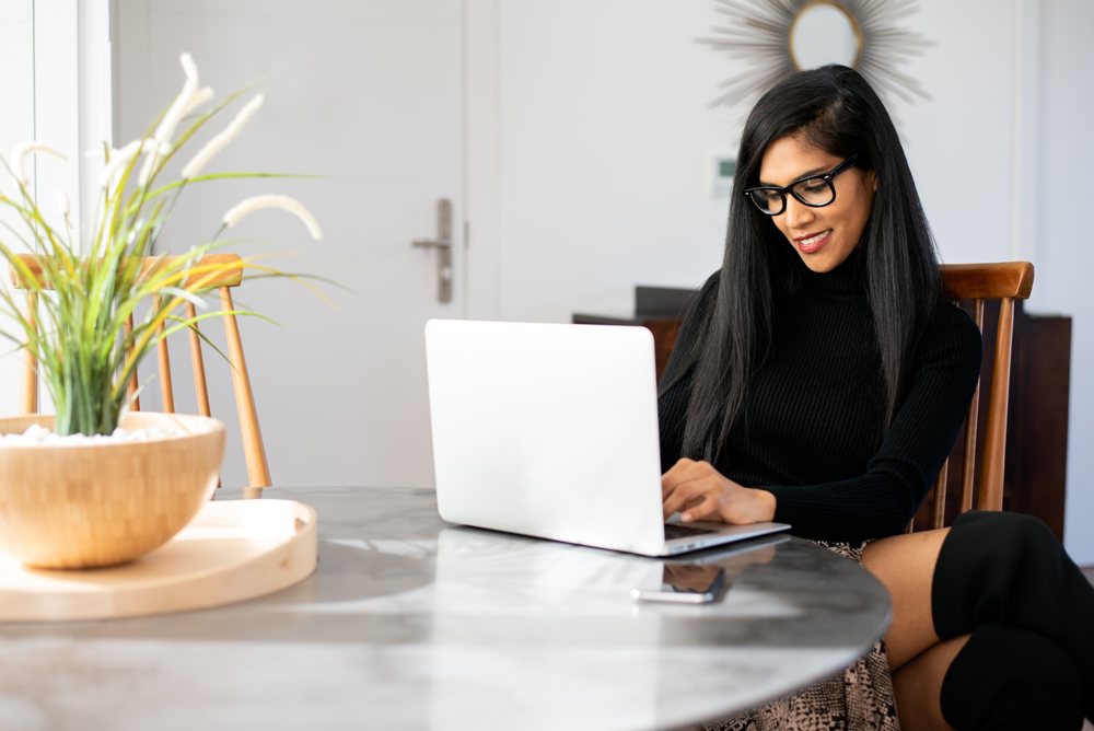 Managing Remote Employees Best Practices And Tech Tips Businesswoman working from home on her computer