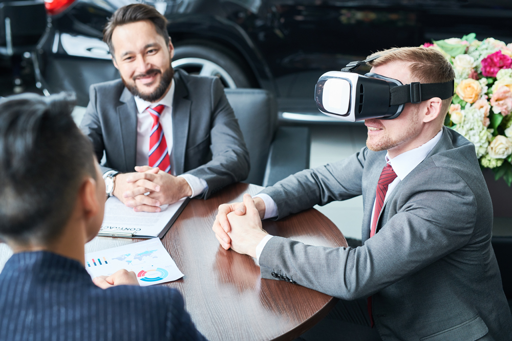 Businessman wearing innovative vr headset sitting at business meeting