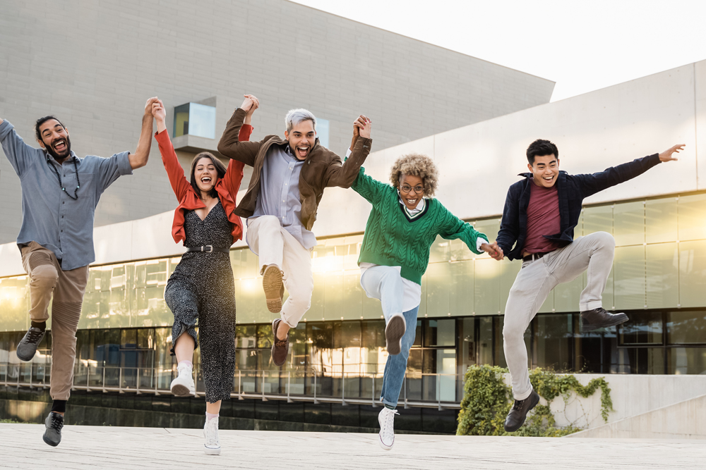 Young diverse people jumping outdoor in the city - Multiracial friends having fun together because the GPU shortage is over