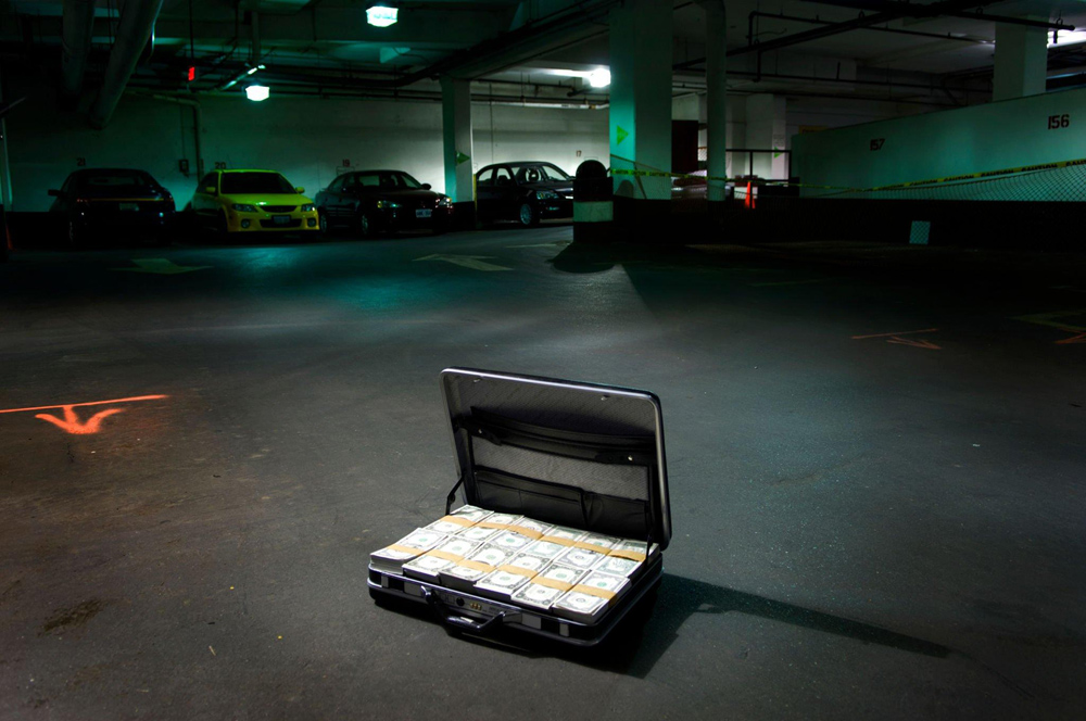 Ransom briefcase full of money in a parking garage