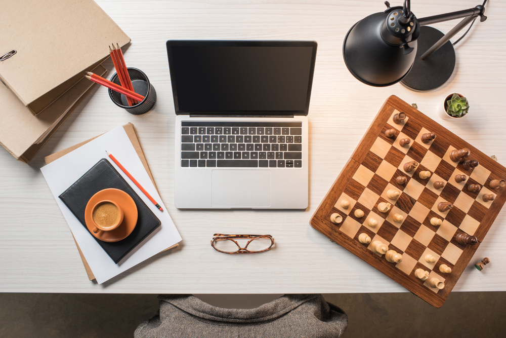 Chessboard next to a computer 
