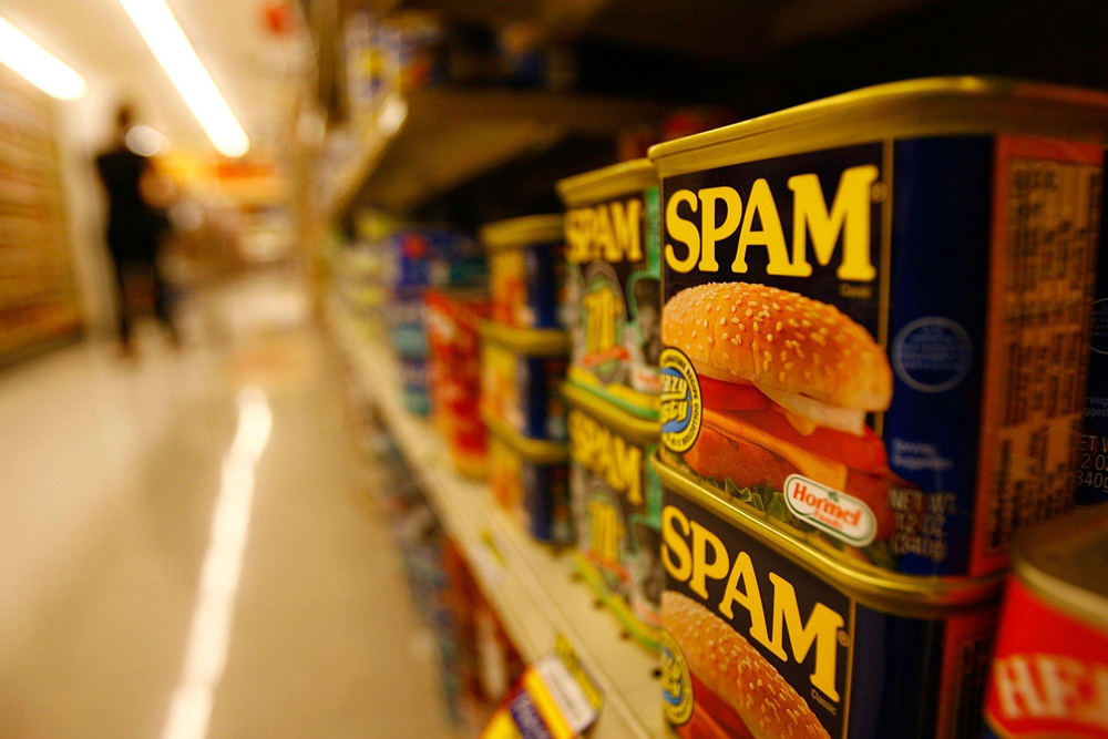 Spam cans on a grocery shelf used to depict Distributed Spam Distraction