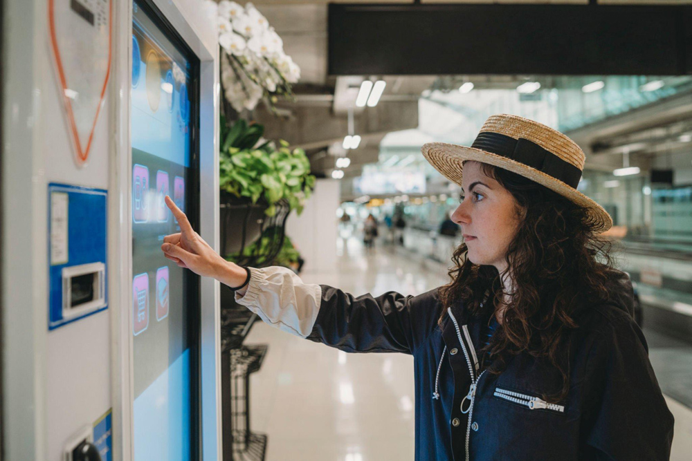 Woman interacting with digital signage in an office building