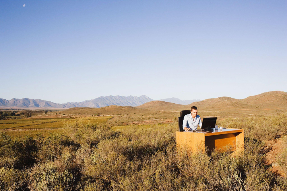 Remote employee working from a dried up field in the middle of the Arizona desert